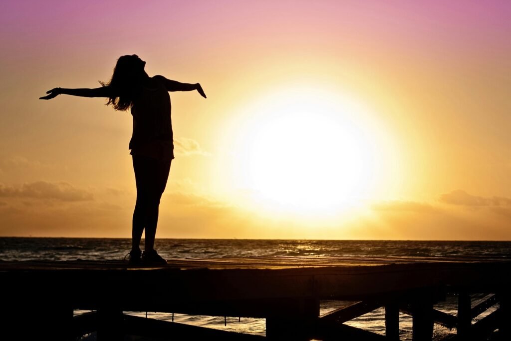Woman standing outside with arms outstretched